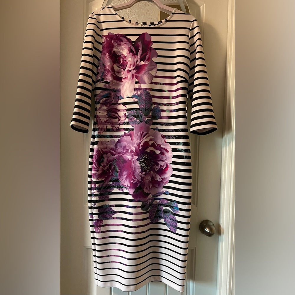Scuba style knee length, women’s size 12 dress. 3/4 sleeves. Beautiful flowers.